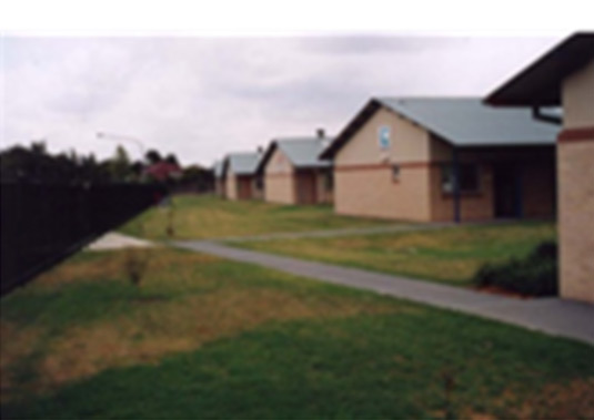 This photo shows the orientation of buildings and the lack of landscape treatment resulting in a poor street address for this school. 