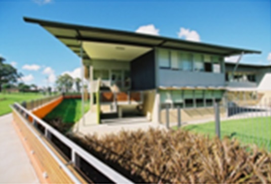 This photo shows a garden bed with a simple shape and the plant selection complements the contemporary style of the school building. This photo was taken from the South Western Sydney Region. 